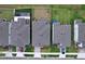 Aerial view of the homes showing roof tops and the fenced in yard at 3063 Marine Grass Dr, Wimauma, FL 33598