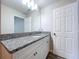 Bathroom featuring single vanity with granite countertop and white cabinets at 3063 Marine Grass Dr, Wimauma, FL 33598