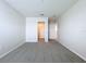 Bright, carpeted bedroom featuring white walls, closet space, and plenty of natural light at 3063 Marine Grass Dr, Wimauma, FL 33598