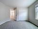 Bedroom featuring carpet flooring, closet and an open doorway to another room at 3063 Marine Grass Dr, Wimauma, FL 33598