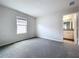 Light-filled bedroom features a window and an open door to a bathroom with granite vanity at 3063 Marine Grass Dr, Wimauma, FL 33598