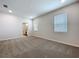 Spacious bedroom features neutral carpet, windows, and an open door to an en-suite bathroom at 3063 Marine Grass Dr, Wimauma, FL 33598