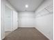 Spacious walk-in closet with carpet flooring and wire shelving system for organization at 3063 Marine Grass Dr, Wimauma, FL 33598