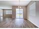 Bright dining room featuring wood-look tile floors and sliding glass doors to the patio at 3063 Marine Grass Dr, Wimauma, FL 33598