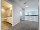 Hallway with carpet flooring showcasing the staircase and bathroom with granite counters at 3063 Marine Grass Dr, Wimauma, FL 33598