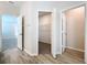 Hallway featuring open doorways to a bedroom and a walk-in closet at 3063 Marine Grass Dr, Wimauma, FL 33598