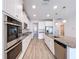 Well-equipped kitchen featuring granite countertops, stainless steel appliances, and an island at 3063 Marine Grass Dr, Wimauma, FL 33598