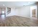 Spacious living room with wood-look tile flooring, staircase, and lots of natural light at 3063 Marine Grass Dr, Wimauma, FL 33598