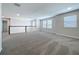 Large upstairs loft area with carpet flooring and plenty of natural light at 3063 Marine Grass Dr, Wimauma, FL 33598