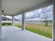 Covered patio overlooking the spacious backyard and waterfront view provides relaxation at 3063 Marine Grass Dr, Wimauma, FL 33598