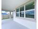 View of the covered patio with windows, offering outdoor living space at 3063 Marine Grass Dr, Wimauma, FL 33598