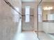 Shower with gray and white tile, a glass door, and a window at 3063 Marine Grass Dr, Wimauma, FL 33598