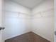 Walk-in closet with carpet flooring, wire shelving, and white walls, providing ample storage space at 3063 Marine Grass Dr, Wimauma, FL 33598