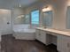 A new primary bathroom features a soaking tub, a walk-in shower, double sinks, and quartz countertops at 31602 Cardinal Yard Dr, San Antonio, FL 33576