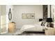 Tastefully decorated bedroom featuring light wood furniture, white linens, stylish artwork, and ample natural light at 31602 Cardinal Yard Dr, San Antonio, FL 33576