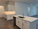 New kitchen boasts white cabinetry, quartz countertops, a center island with a sink, and stainless appliances at 31602 Cardinal Yard Dr, San Antonio, FL 33576
