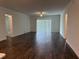 Spacious living room with wood-look tile flooring, a ceiling fan, and sliding glass doors at 31602 Cardinal Yard Dr, San Antonio, FL 33576