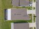 A high-angle view of a home with a screened-in patio, enhanced by manicured landscaping and a spacious private driveway at 31775 Sun Kettle Loop Loop, Wesley Chapel, FL 33545