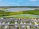 An aerial view of a home, showcasing the property, neighborhood, and nearby lake at 31775 Sun Kettle Loop Loop, Wesley Chapel, FL 33545