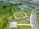 Aerial view of neighborhood park featuring a playground, dog park, and walking paths at 31775 Sun Kettle Loop Loop, Wesley Chapel, FL 33545