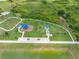 Aerial view highlights a neighborhood park with dog park and playground areas for community enjoyment at 31775 Sun Kettle Loop Loop, Wesley Chapel, FL 33545