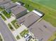 An aerial perspective showcasing a home with a screened-in patio and a lush, green backyard with well-kept landscaping at 31775 Sun Kettle Loop Loop, Wesley Chapel, FL 33545