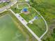 Aerial view showcasing a playground with slides, a covered seating area, and walking paths at 31775 Sun Kettle Loop Loop, Wesley Chapel, FL 33545