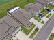 Aerial view showcases a home with a screened-in patio, complemented by landscaped greenery and a long private driveway at 31775 Sun Kettle Loop Loop, Wesley Chapel, FL 33545