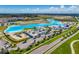 Stunning aerial view of a community lagoon with amenities and easy access to nearby roadways at 31775 Sun Kettle Loop Loop, Wesley Chapel, FL 33545