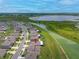 Aerial view of a charming home in a well-planned community next to a tranquil lake at 31775 Sun Kettle Loop Loop, Wesley Chapel, FL 33545