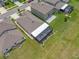 Aerial image showcases a home's backyard, featuring a screened-in patio with outdoor seating and manicured landscaping at 31775 Sun Kettle Loop Loop, Wesley Chapel, FL 33545