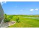 Serene backyard view with well-maintained lawn, landscaping, and picturesque lake views at 31775 Sun Kettle Loop Loop, Wesley Chapel, FL 33545