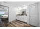 Bright bathroom with double sinks, granite countertops, white cabinets, and a view of the bedroom at 31775 Sun Kettle Loop Loop, Wesley Chapel, FL 33545