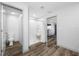 Modern bathroom featuring a walk-in shower and a separate toilet room, complemented by stylish wood floors at 31775 Sun Kettle Loop Loop, Wesley Chapel, FL 33545