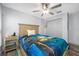 Cozy bedroom with ceiling fan, wood-look flooring, and a playful decor at 31775 Sun Kettle Loop Loop, Wesley Chapel, FL 33545