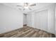 Empty bedroom featuring wood-look flooring, ceiling fan, and closet at 31775 Sun Kettle Loop Loop, Wesley Chapel, FL 33545
