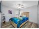 Stylish bedroom with ceiling fan, wood-look flooring, and decor at 31775 Sun Kettle Loop Loop, Wesley Chapel, FL 33545