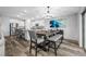 Dining area with modern decor, a large table, and access to the open-concept kitchen at 31775 Sun Kettle Loop Loop, Wesley Chapel, FL 33545