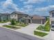 Charming exterior of a home with a beautifully landscaped front yard, offering great curb appeal in a residential neighborhood at 31775 Sun Kettle Loop Loop, Wesley Chapel, FL 33545