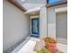 Home featuring a stylish blue door and manicured landscaping in a quiet neighborhood at 31775 Sun Kettle Loop Loop, Wesley Chapel, FL 33545