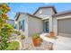 Lovely home showcasing a colorful garden, a quaint walkway, and a two-car garage at 31775 Sun Kettle Loop Loop, Wesley Chapel, FL 33545