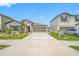 Charming single story home with well-kept lawn and a spacious concrete driveway at 31775 Sun Kettle Loop Loop, Wesley Chapel, FL 33545