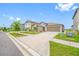 Suburban home featuring a big driveway, landscaped front yard, and side view of lake at 31775 Sun Kettle Loop Loop, Wesley Chapel, FL 33545