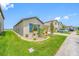 Inviting one-story home with a well-manicured front yard and a pristine green lawn at 31775 Sun Kettle Loop Loop, Wesley Chapel, FL 33545