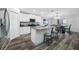Modern kitchen with white cabinets, stainless appliances, and a granite countertop island at 31775 Sun Kettle Loop Loop, Wesley Chapel, FL 33545