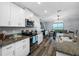 Modern kitchen with a dining area, white cabinets, and granite countertops at 31775 Sun Kettle Loop Loop, Wesley Chapel, FL 33545