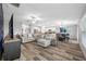 Bright open-concept living space with stylish furnishings and hardwood floors at 31775 Sun Kettle Loop Loop, Wesley Chapel, FL 33545