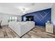 Bright living room with an accent wall, large couch, and laminate floors at 31775 Sun Kettle Loop Loop, Wesley Chapel, FL 33545