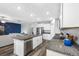 Open concept view of the kitchen and living room with the dark blue feature wall at 31775 Sun Kettle Loop Loop, Wesley Chapel, FL 33545
