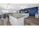 Open floor plan with kitchen, dining area, and living room featuring modern design at 31775 Sun Kettle Loop Loop, Wesley Chapel, FL 33545